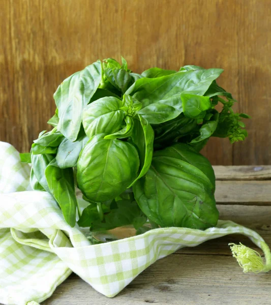 Bunch of fresh green basil on a wooden table — Stock Photo, Image