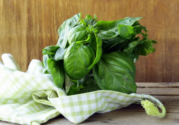 Bunch of fresh green basil on a wooden table — Stock Photo, Image