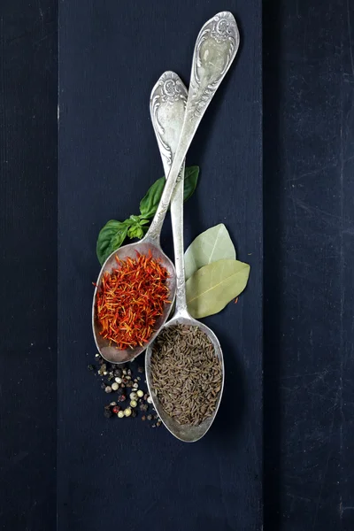 Spice saffron and cumin in a vintage spoons — Stock Photo, Image