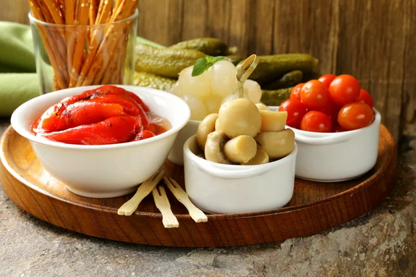 Pickled snacks (tapas) - mushrooms, tomatoes, cucumbers and pearl onions — Stock Photo, Image