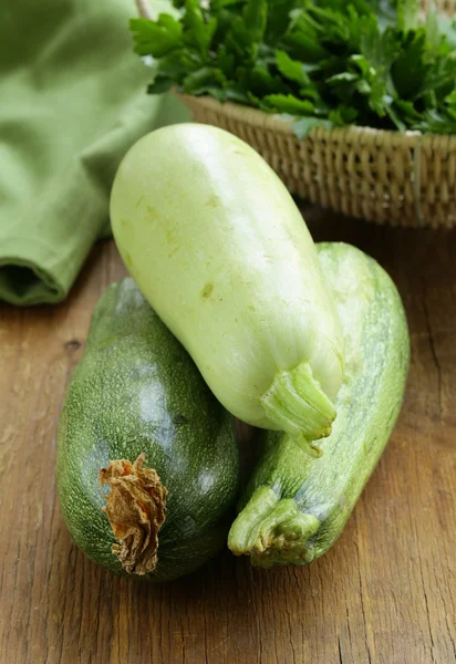 Fresh green zucchini on a wooden table — Stock Photo, Image