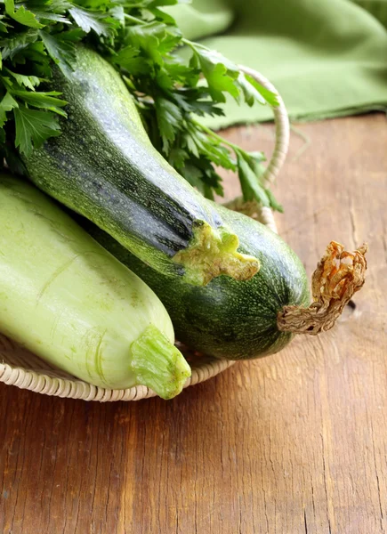Fresh green zucchini on a wooden table — Stock Photo, Image