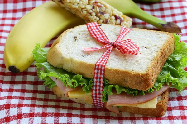 Сэндвич с ветчиной, яблоком, бананом и батончиком - здоровое питание, школьный обед — стоковое фото