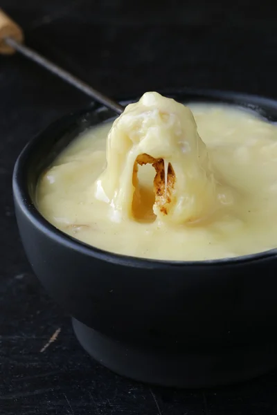 Cheese fondue - piece of bread (croutons) in a liquid cheese — Stock Photo, Image