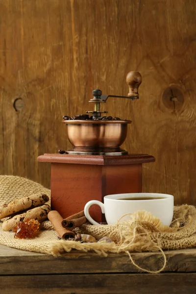 Still life of wooden coffee grinder, sugar, biscuits — Stock Photo, Image