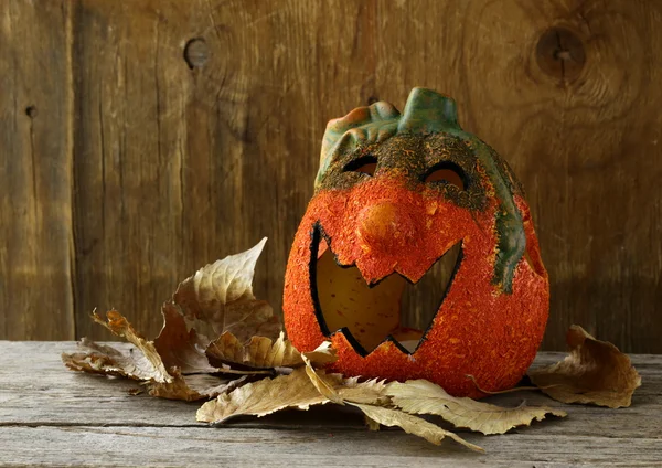 Halloween pumpkin Jack O'Lantern on a wooden background — Stock Photo, Image