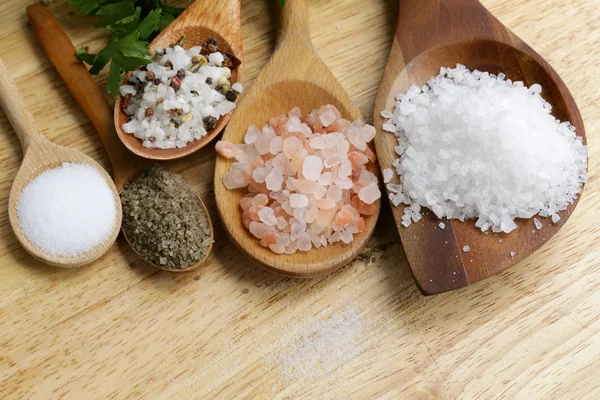 Different types of salt (pink, sea, black, and with spices) — Stock Photo, Image