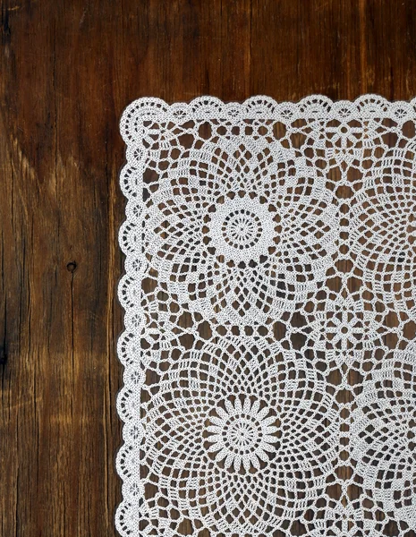 Wooden background with white lace napkin — Stock Photo, Image