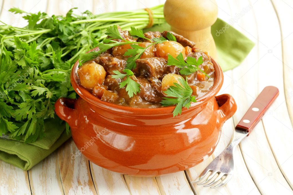 Beef stew with vegetables and herbs in a clay pot - comfort food
