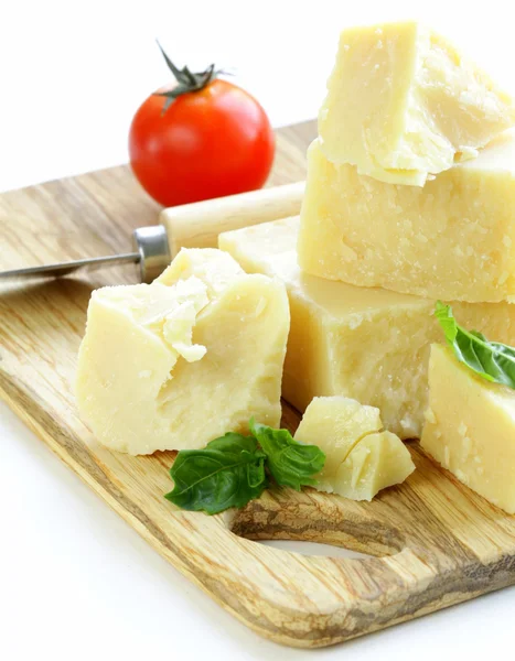 Hard natural parmesan cheese on a wooden board — Stock Photo, Image