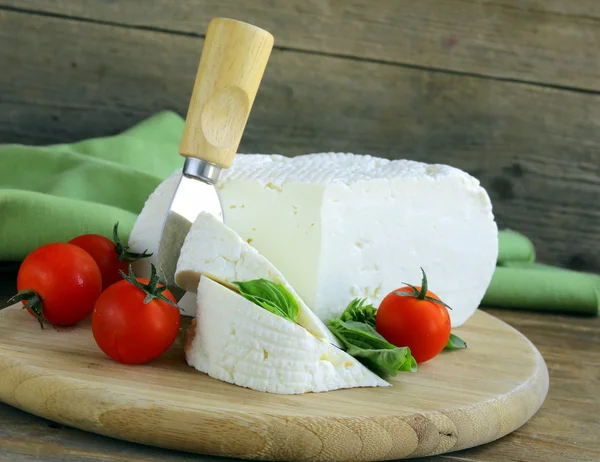 Salted milk cheese (feta cheese) on a wooden chopping board — Stock Photo, Image