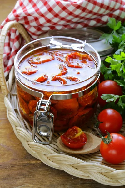 Sun-dried tomatoes with herbs and olive oil in the pot — Stock Photo, Image