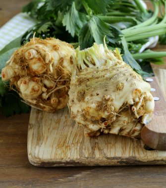 Fresh organic celery root with green leaves clipart