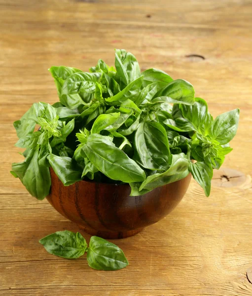 Fresh green basil on a wooden background — Stock Photo, Image
