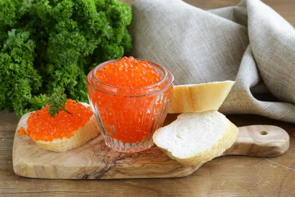 Delicacy appetizer red caviar on a white baguette — Stock Photo, Image