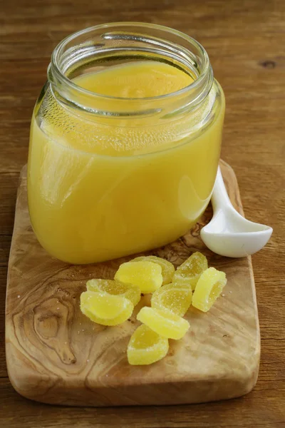 Homemade lemon curd in glass jar on a wooden table — Stock Photo, Image