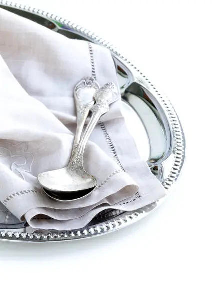 Vintage cutlery with old-fashioned napkin on a silver tray — Stock Photo, Image