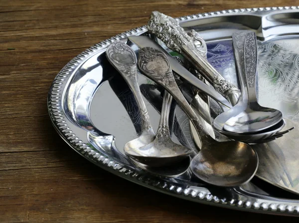 Vintage cutlery with old-fashioned napkin on a silver tray — Stock Photo, Image