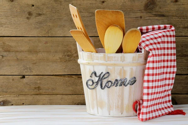 Wooden kitchen utensils on a wooden background — Stock Photo, Image