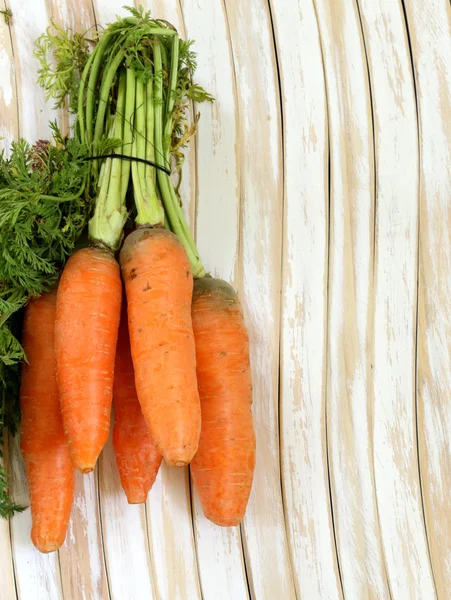 Ripe orange organic carrots on the wooden table — Stock Photo, Image