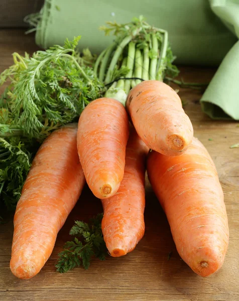 Ripe orange organic carrots on the wooden table — Stock Photo, Image