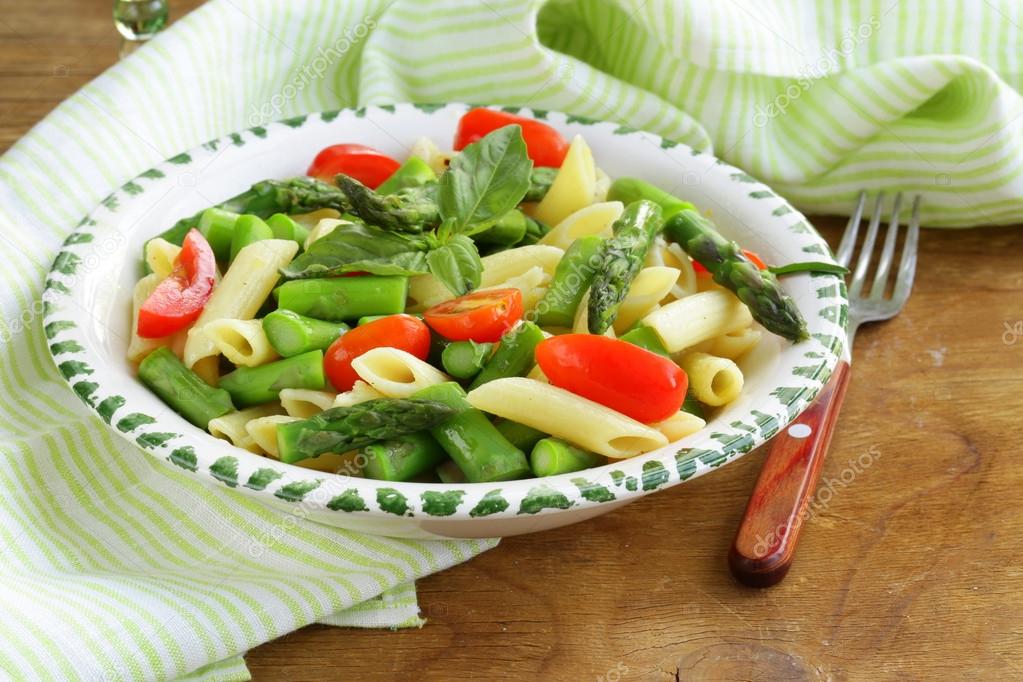 Penne pasta with tomatoes and asparagus, fresh spring food
