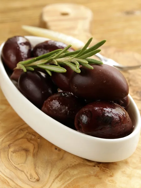Ripe black kalamata olives in a white bowl — Stock Photo, Image