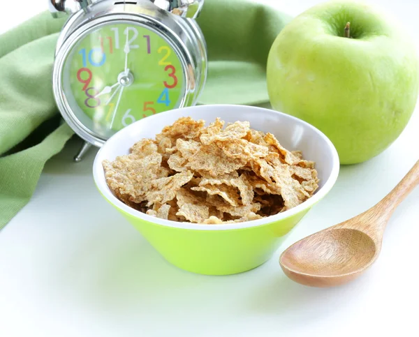 Healthy breakfast - muesli and apple (alarm clock in the background) — Stock Photo, Image