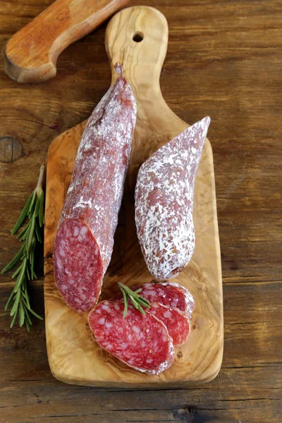 Delicacy smoked sausage (pepperoni) on a cutting board — Stock Photo, Image