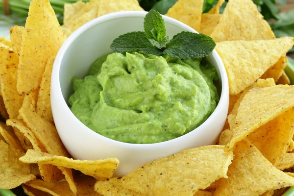 Cup with guacamole and corn chips — Stock Photo, Image