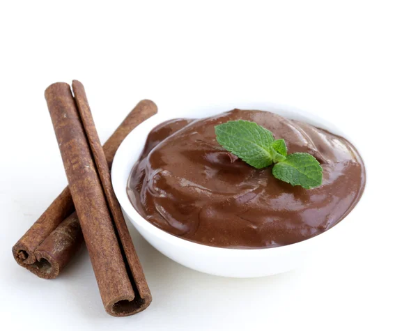 Chocolate spread with cinnamon sticks on a white background — Stock Photo, Image