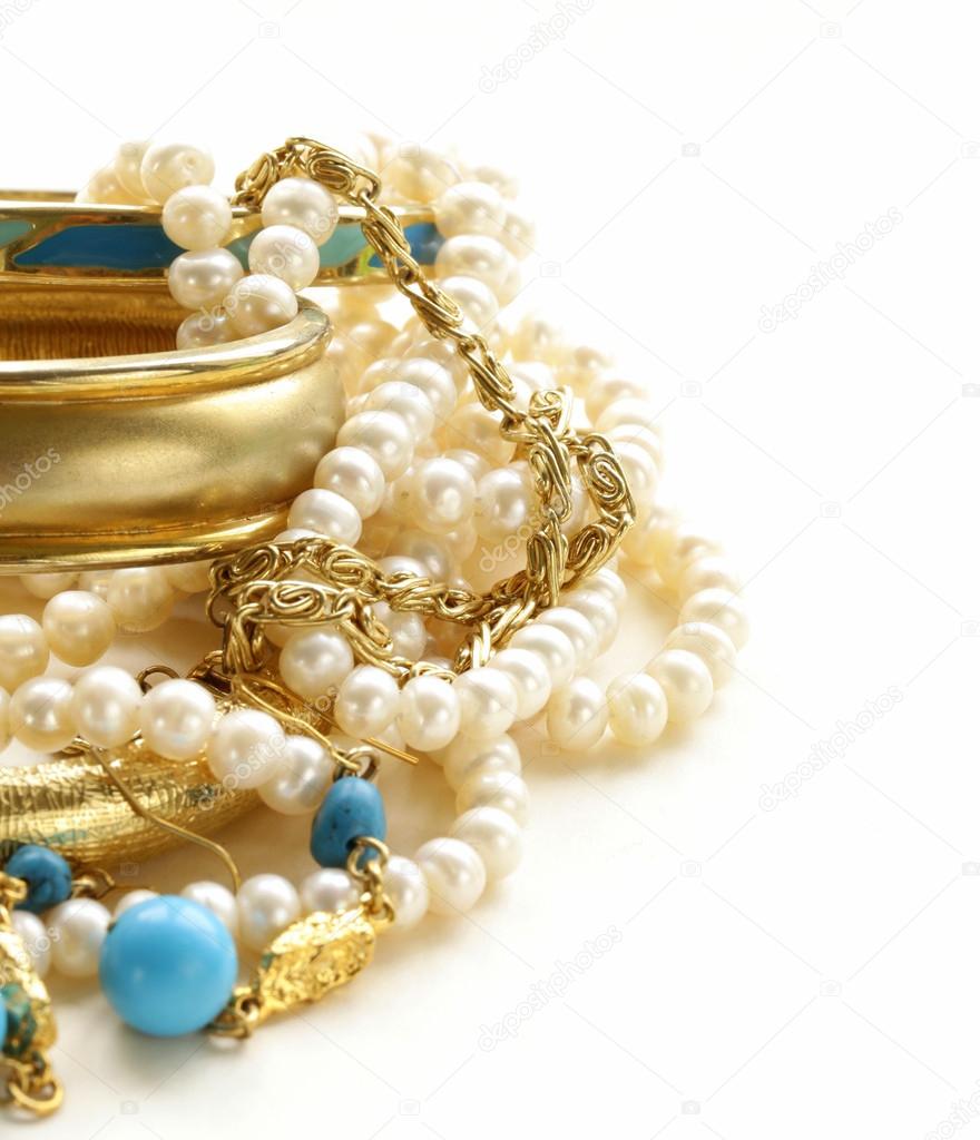 Gold, turquoise jewelry and pearl, on a white background