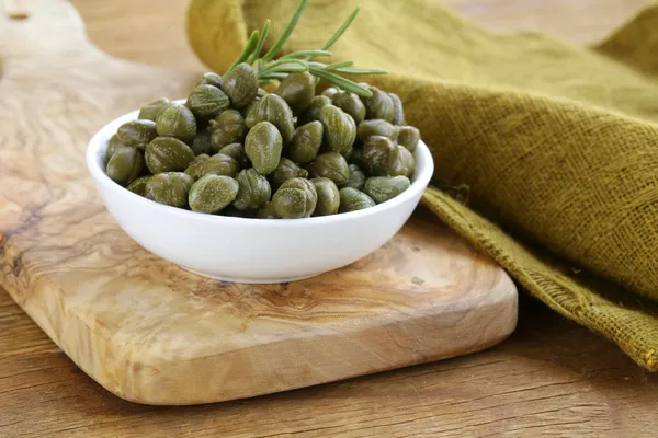 Alcaparras en escabeche en tazón blanco —  Fotos de Stock