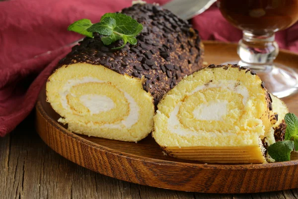 Vanilla roll cake with chocolate ganache and creamy cream — Stock Photo, Image