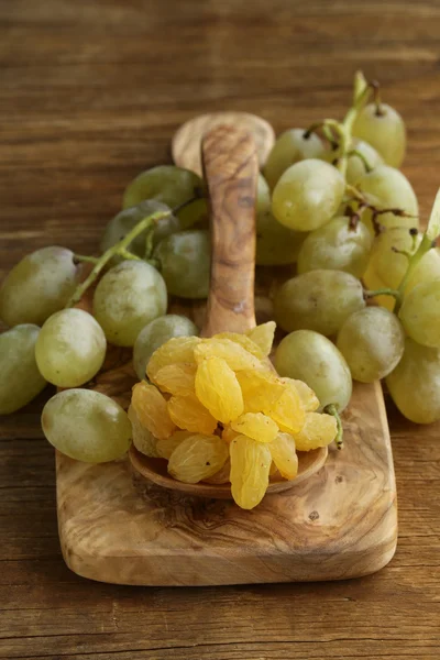 Uvas brancas secas (passas) em uma mesa de madeira — Fotografia de Stock