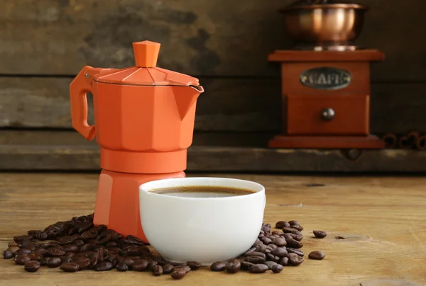 Still life of coffee beans and coffee maker, cup of espresso on vintage wooden background — Stock Photo, Image