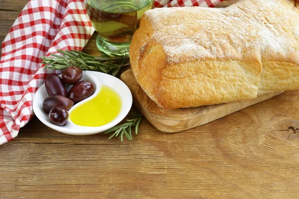 Still life in the Italian style - ciabatta bread, olive and oil — Stock Photo, Image