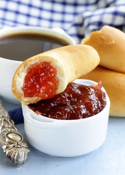 Strawberry jam and bread rolls with a cup of coffee for breakfast — Stock Photo, Image
