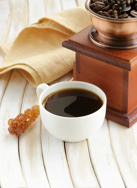 Wooden coffee grinder and espresso cup on the table — Stock Photo, Image