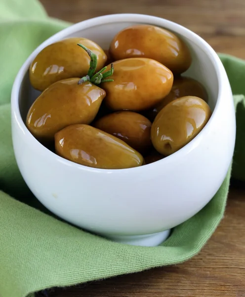 Green marinated olives in a white bowl — Stock Photo, Image