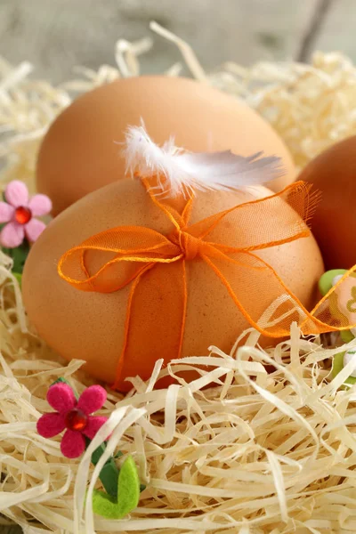 Easter eggs in nest on a wooden background — Stock Photo, Image