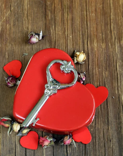 Still life red heart with key on the old wooden background — Stock Photo, Image