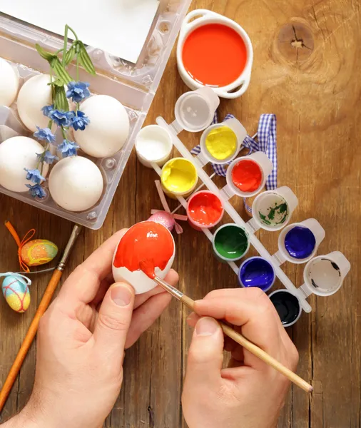 Coloring Easter eggs (hand in the shot) paint and brushes — Stock Photo, Image
