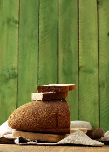 Loaf of rye bread on a wooden table rustic style — Stock Photo, Image