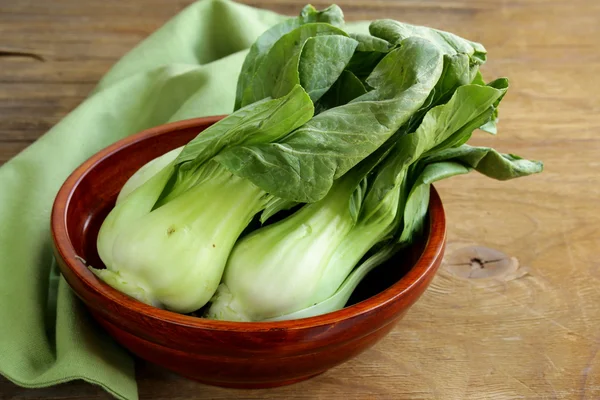 Bok choy (chinese cabbage) on a wooden table — Stock Photo, Image