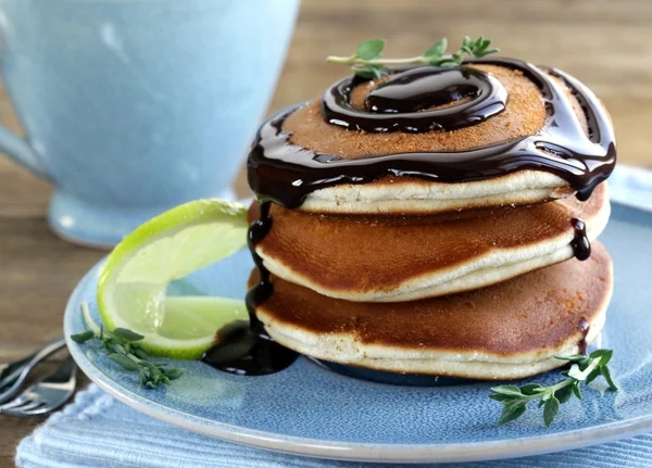 Homemade pancakes with chocolate syrup and thyme — Stock Photo, Image