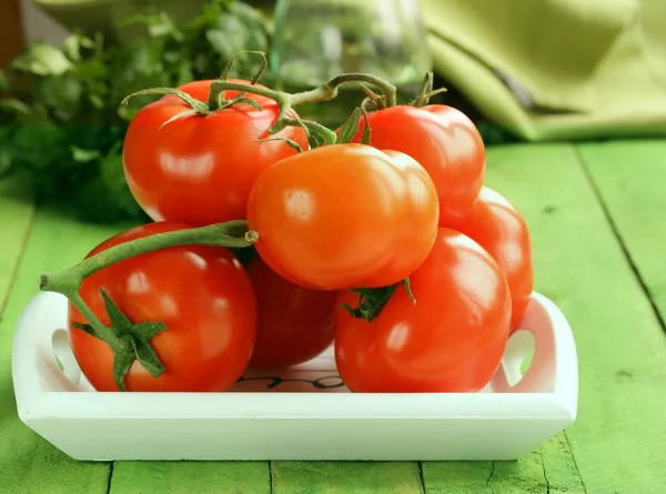 Tomates ecológicos frescos y maduros sobre una mesa de madera — Foto de Stock