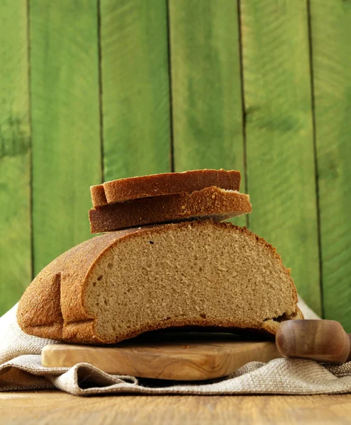 Loaf of rye bread on a wooden table rustic style — Stock Photo, Image