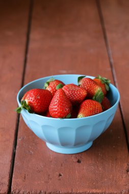 mavi bir kase IPE sulu çilek