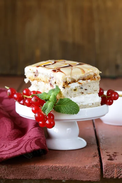 Pedazo de pastel de vainilla decorado salsa de caramelo y grosella —  Fotos de Stock